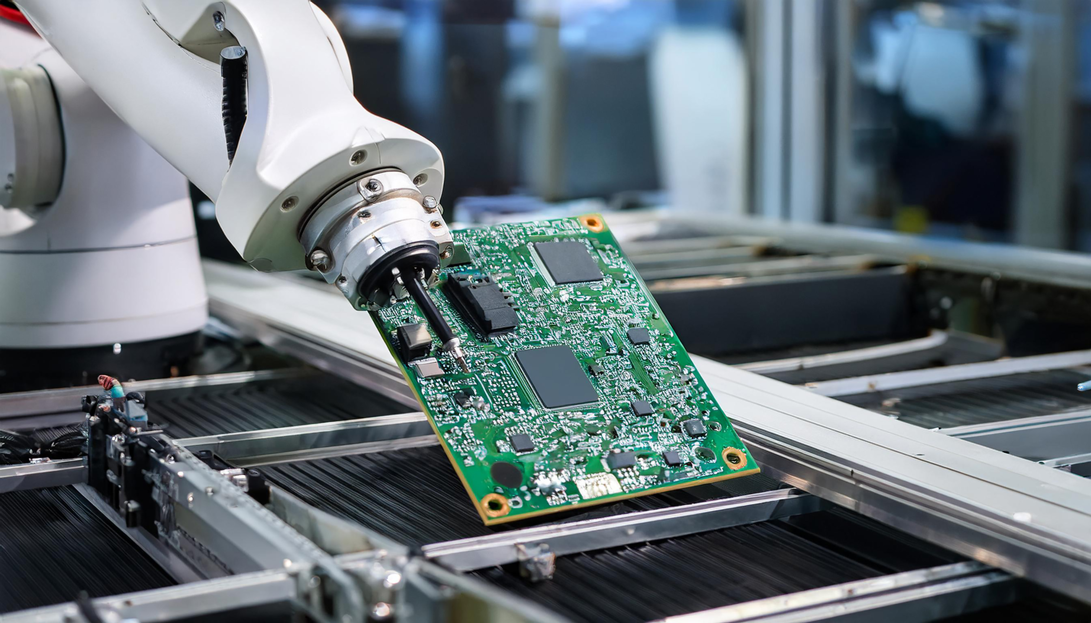 robot arm assembling circuit boards modern factory setting